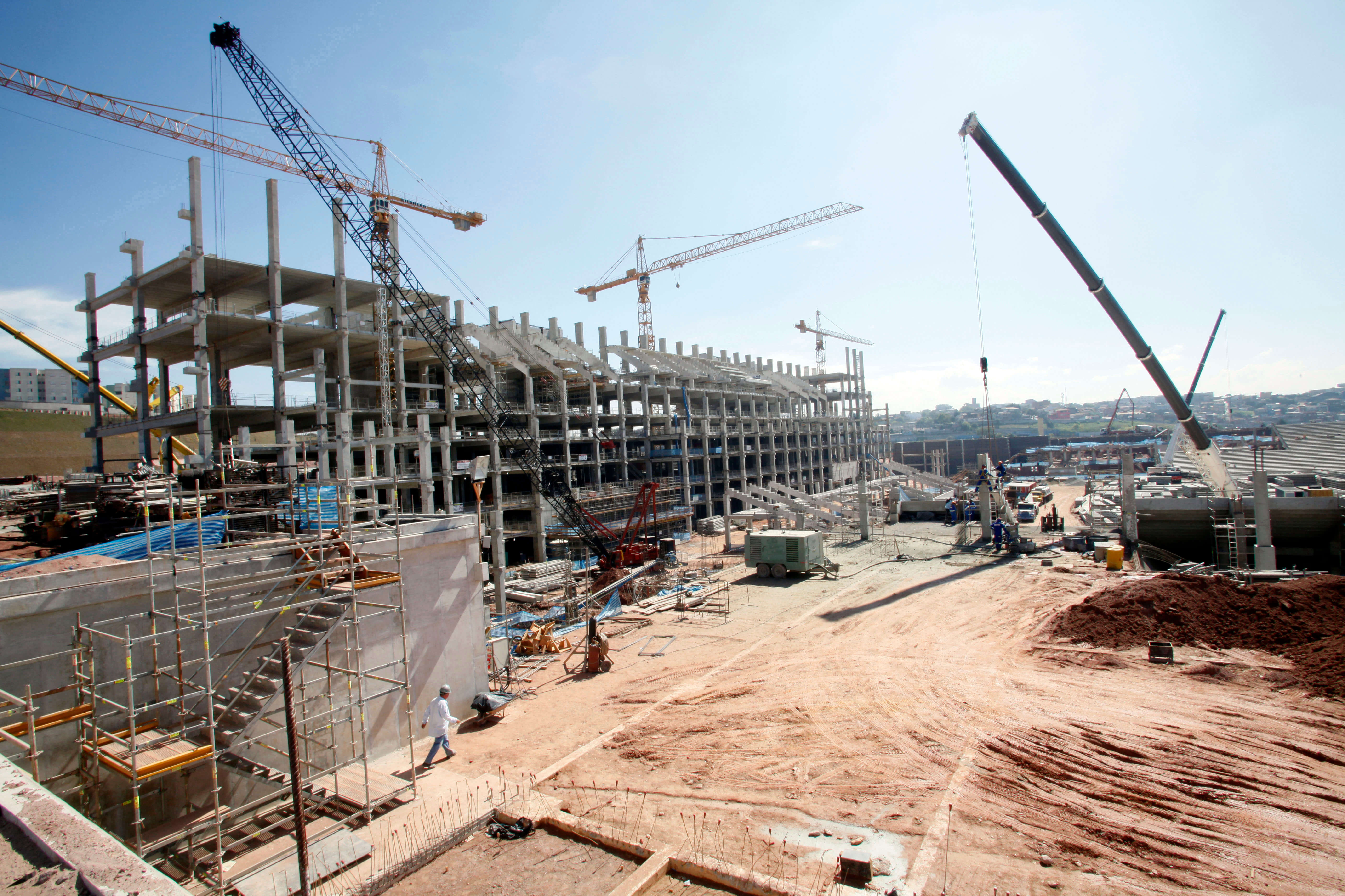 Construction site with employees and excavators. 